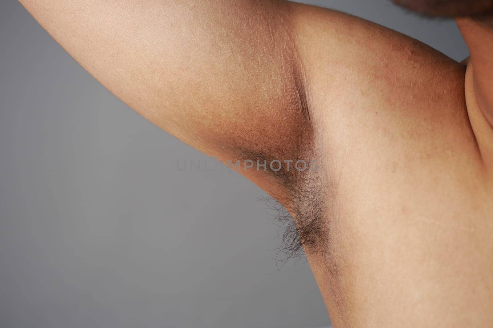 young man raised his hand up and showing his unshaven armpit by towfiq007