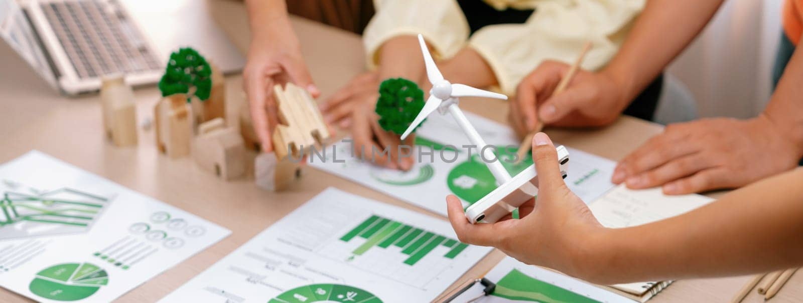 Windmill model placed during presenting green business. Closeup. Delineation. by biancoblue