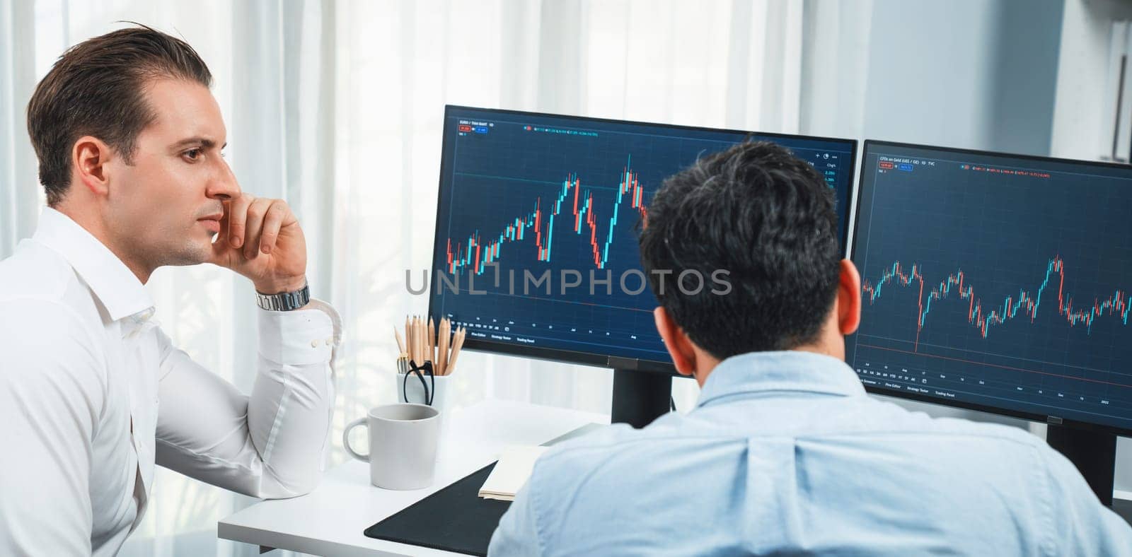 Traders discussing with two market stock screen on panorama view,. Sellable. by biancoblue