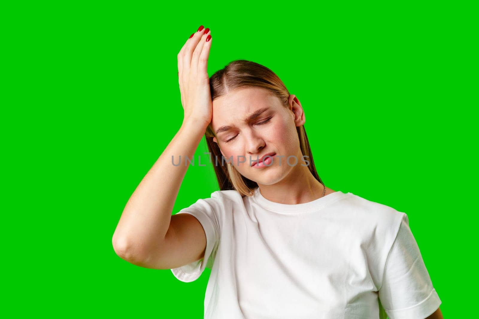 Young Woman Holding Head With Hands Headache Concept on green background