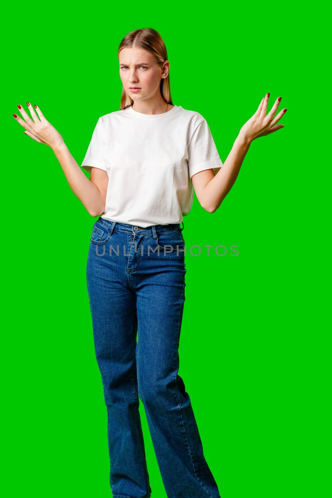 Young Woman Holding Out Hands against green background in studio