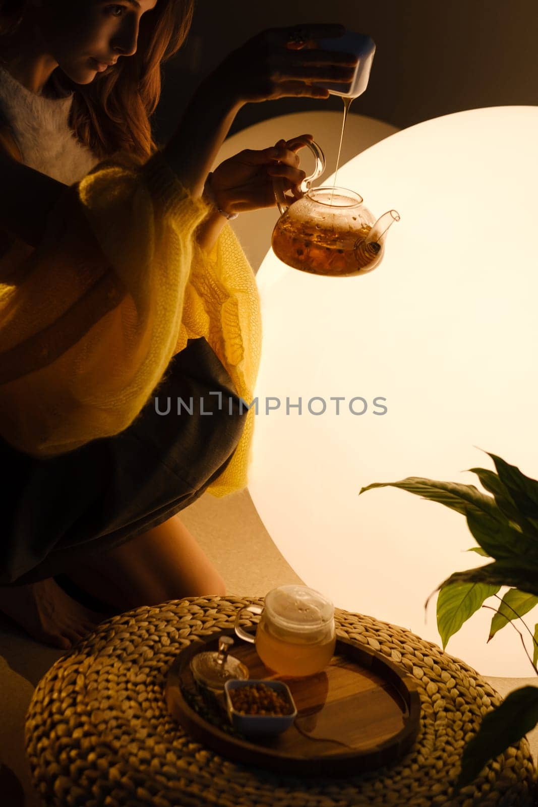 A young girl conducts an evening tea drinking procedure indoors. Relaxing tea party by Lobachad