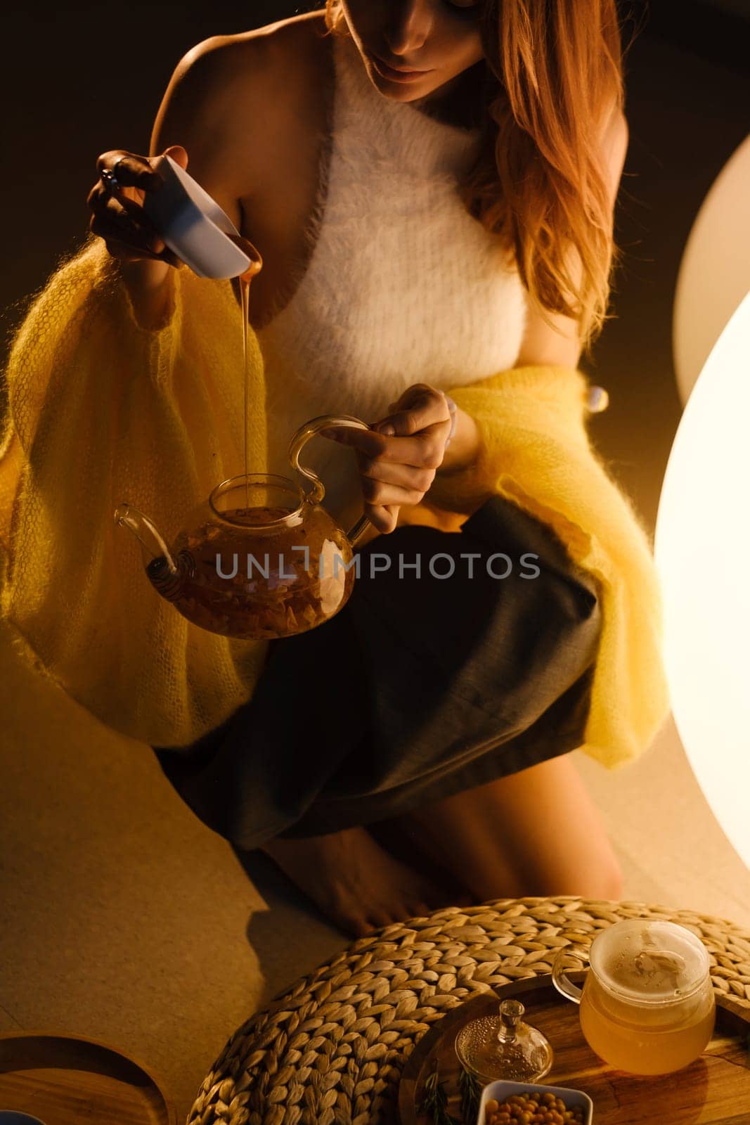 A young girl conducts an evening tea drinking procedure indoors. Relaxing tea party.