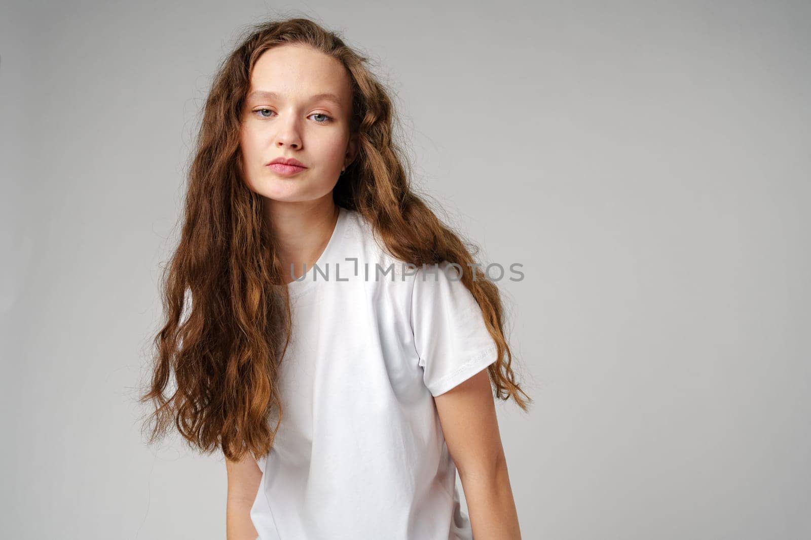 Young Girl With Long Curly Hair Portrait in studio