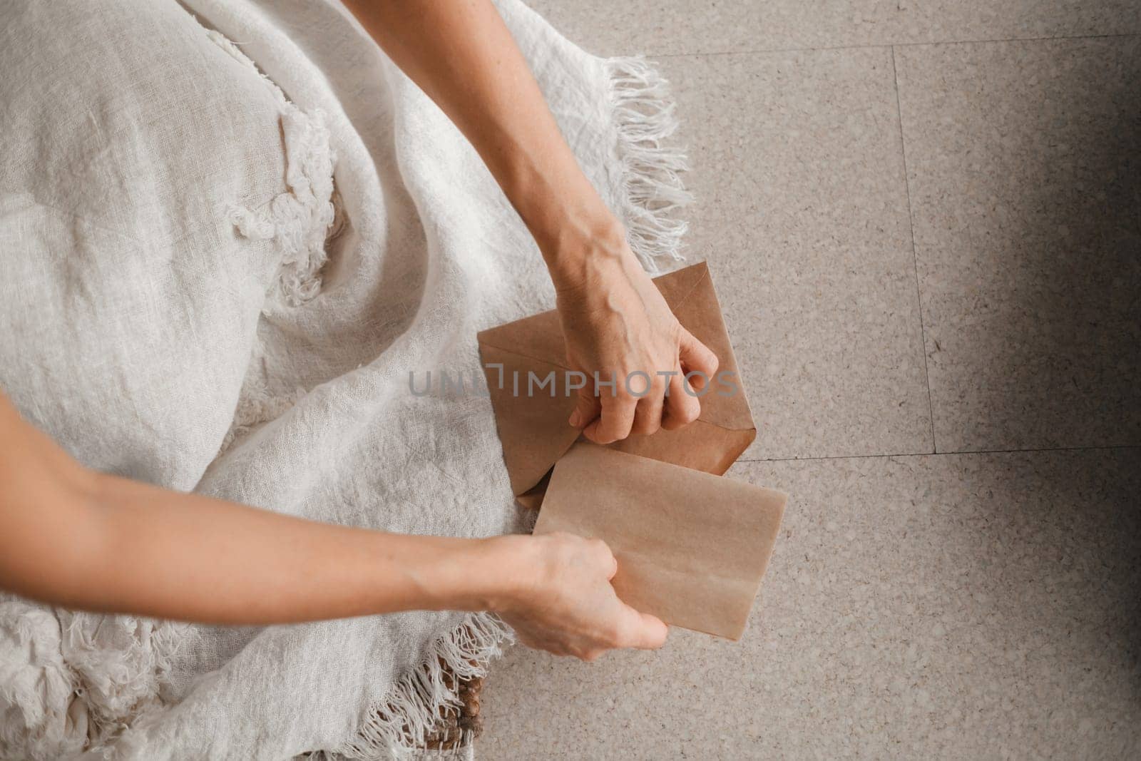 A woman in white clothes holds an envelope with a wish in her hands. The concept of a women's circle by Lobachad
