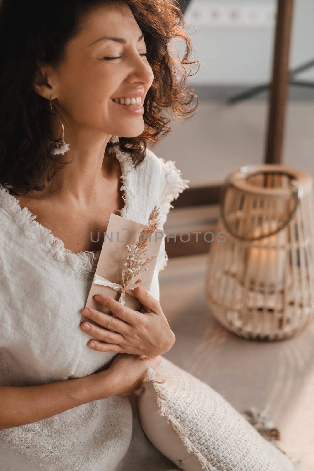 A woman in white clothes holds an envelope with a wish in her hands. The concept of a women's circle.