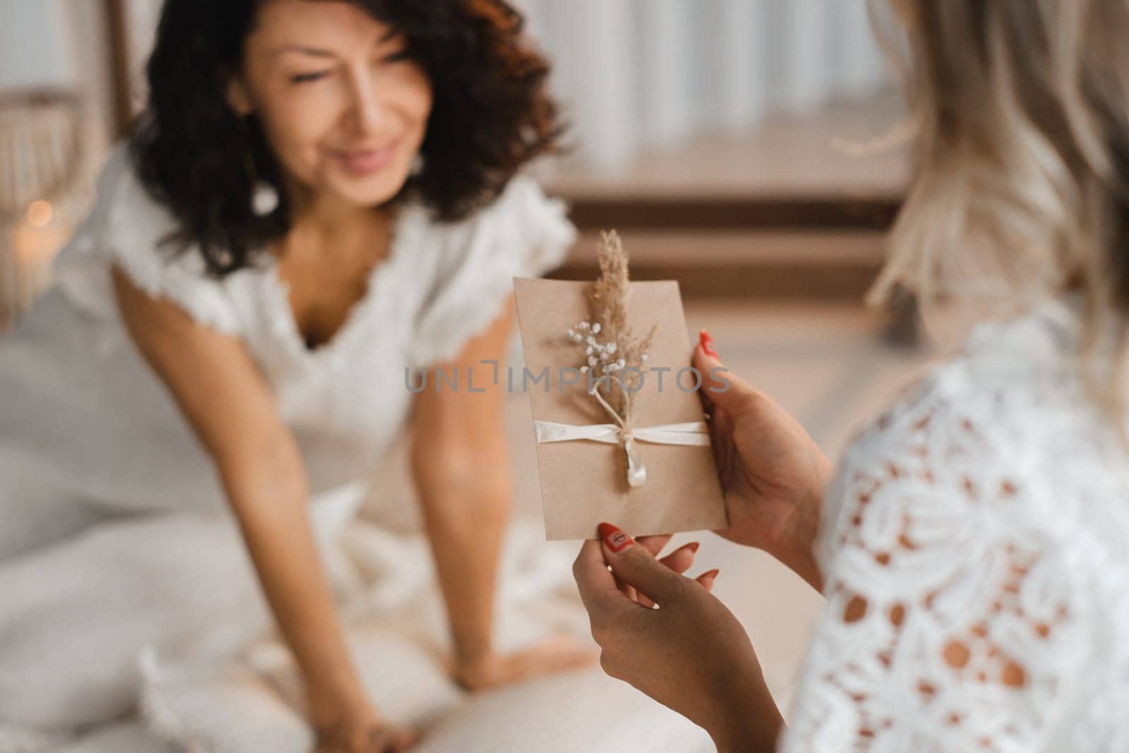 A woman in white clothes holds an envelope with a wish in her hands. The concept of a women's circle.