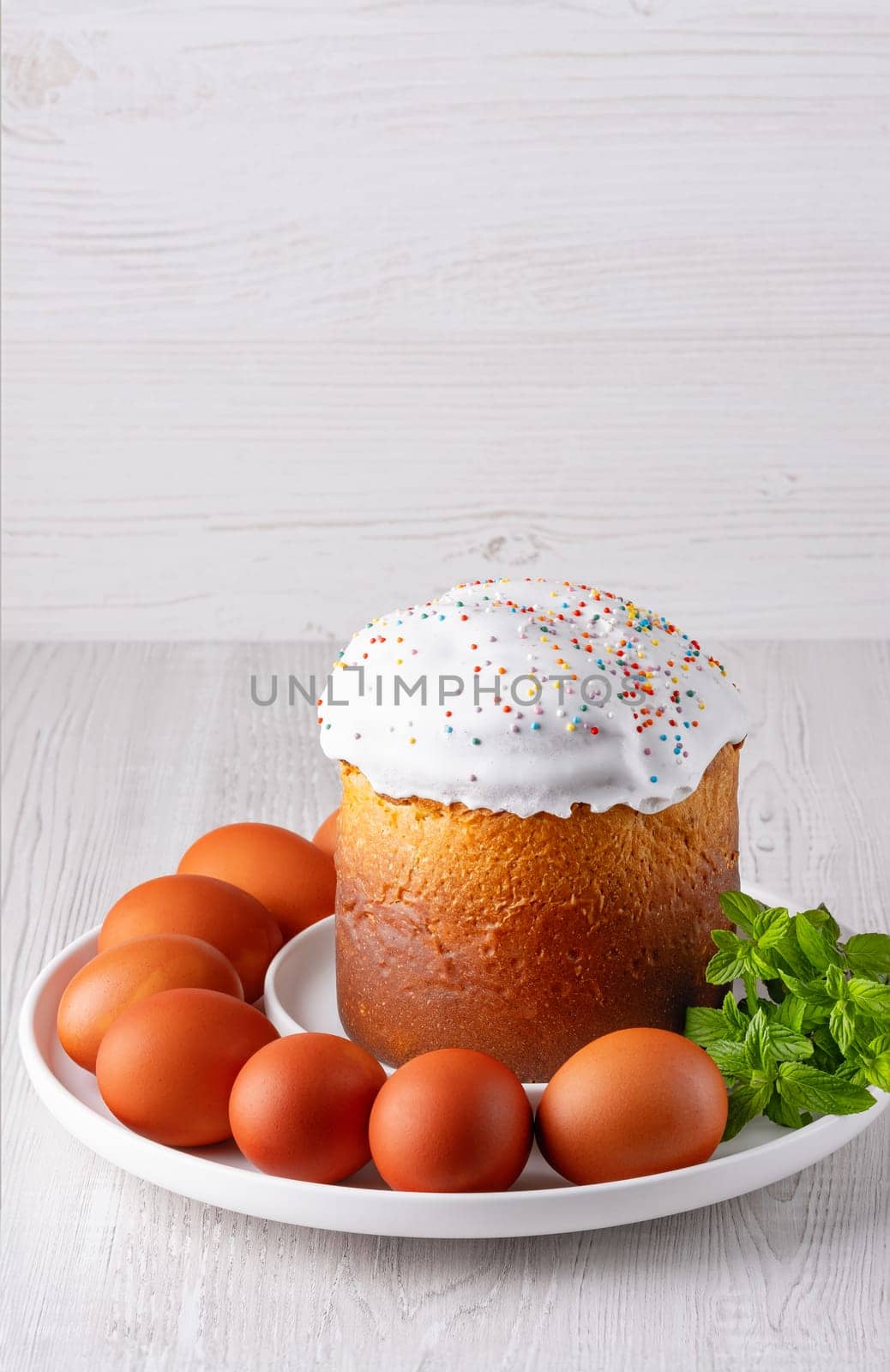 Delicious Easter cake and eggs on light background, with copy space for text.