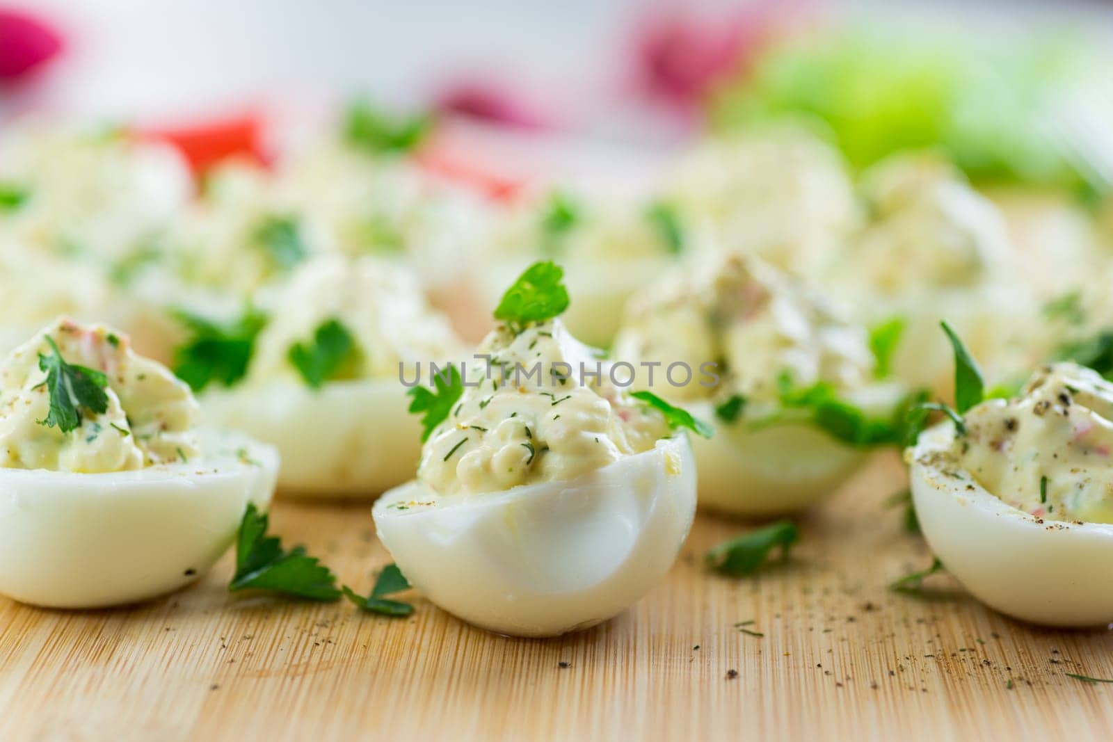 stuffed eggs, deviled eggs on a wooden table .