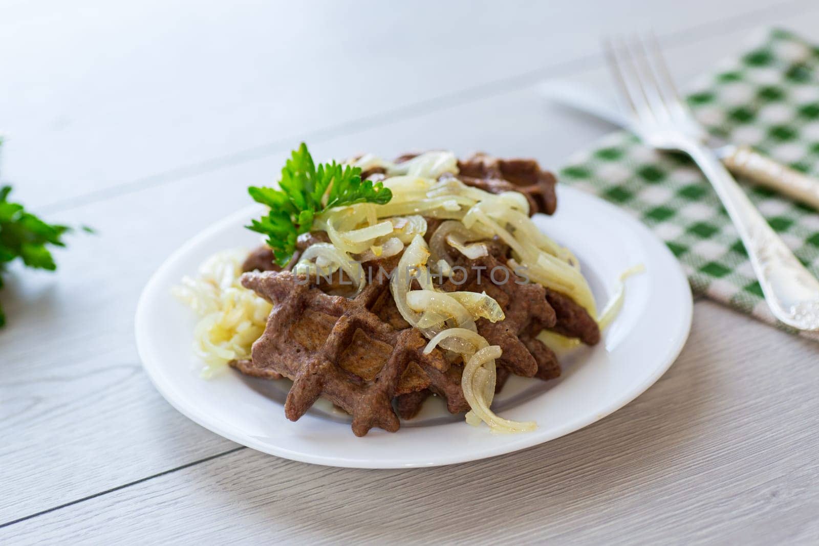 fried liver waffles with onions and herbs .