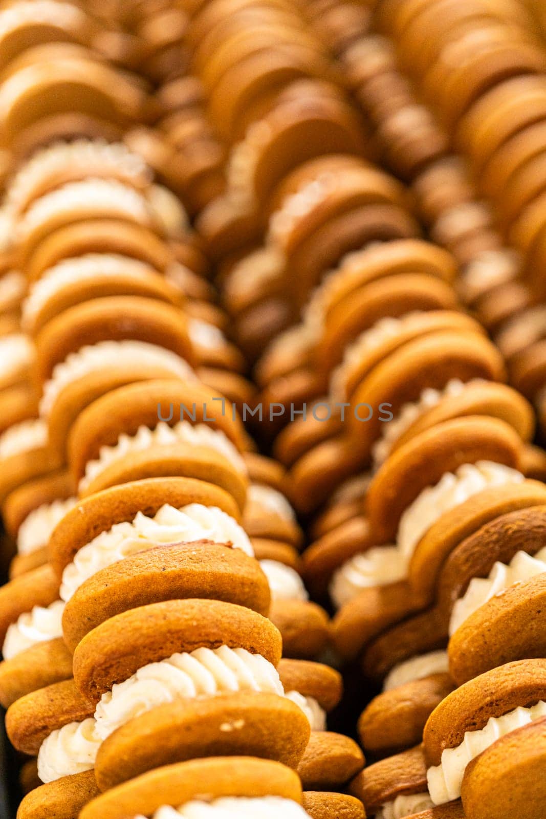 Making Festive Gingerbread Sandwiches on Rustic Wooden Table by arinahabich