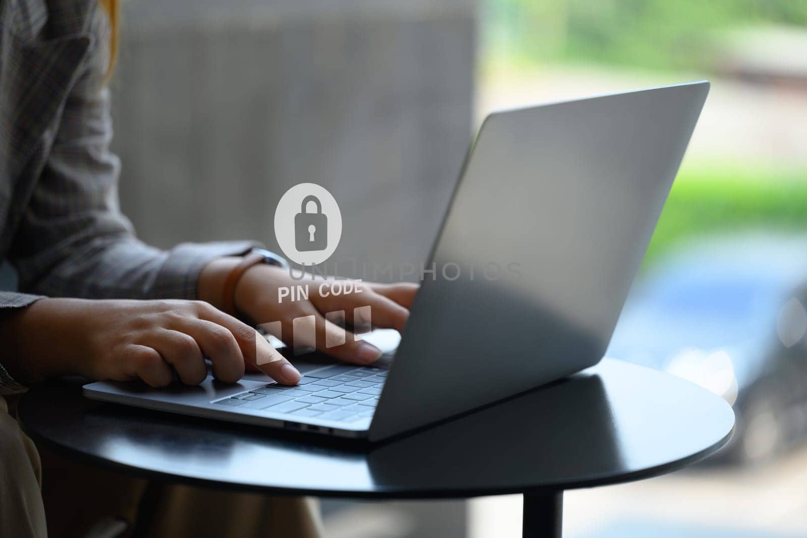 Unrecognizable businesswoman entering pin code on laptop. Cybersecurity concept by prathanchorruangsak
