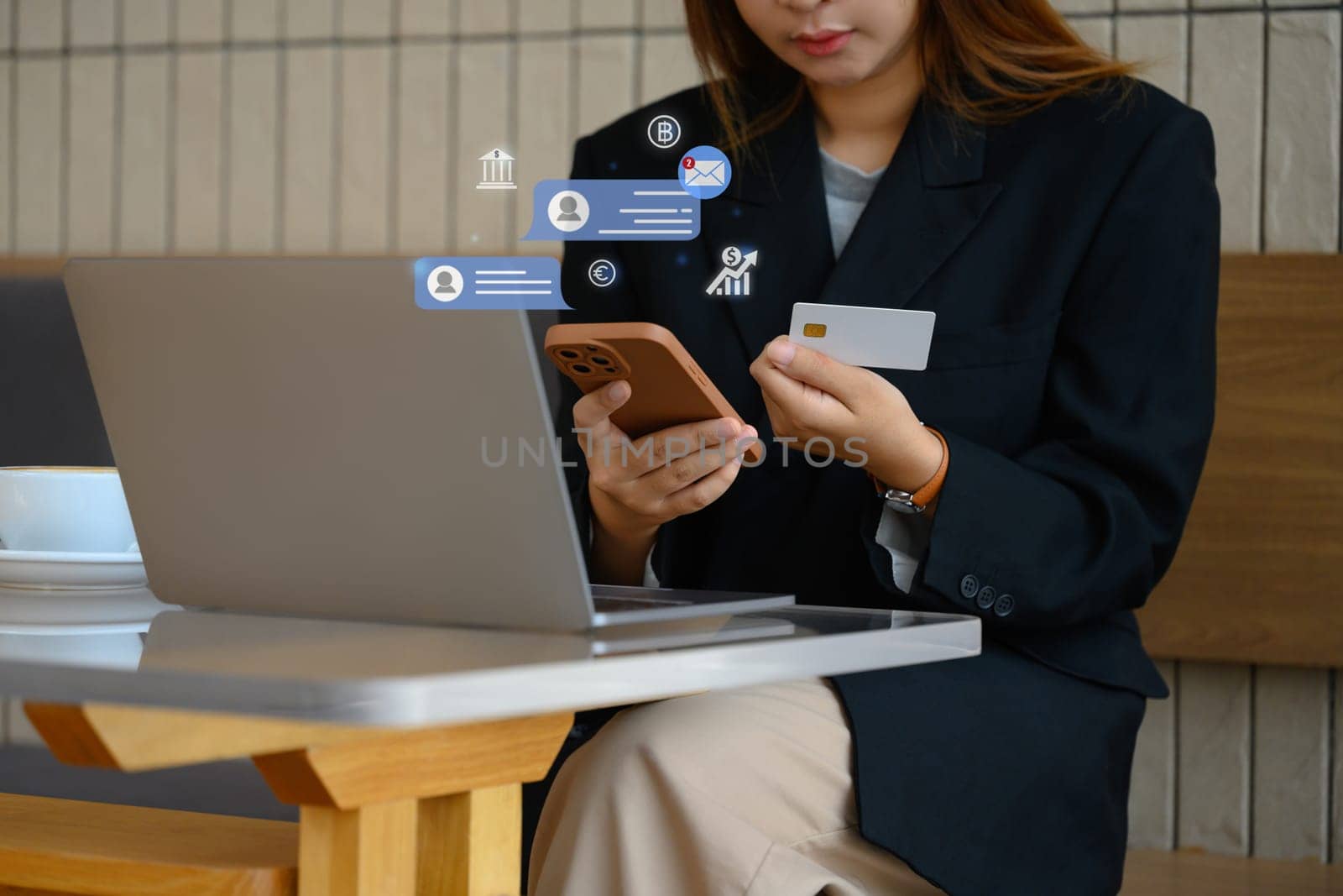 Young businessman holding credit card shopping online on her smartphone.