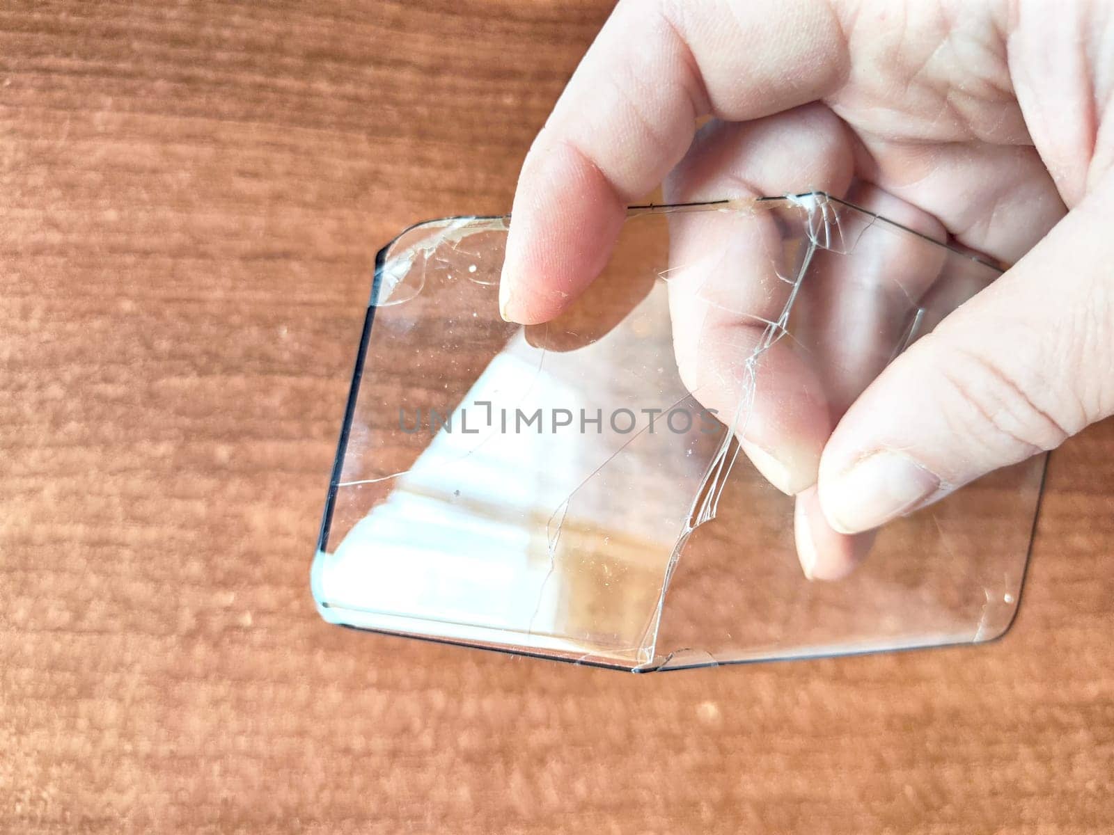 Removing Protective Film From a Cracked Screen. Peeling off a cracked screen protector from a phone by keleny