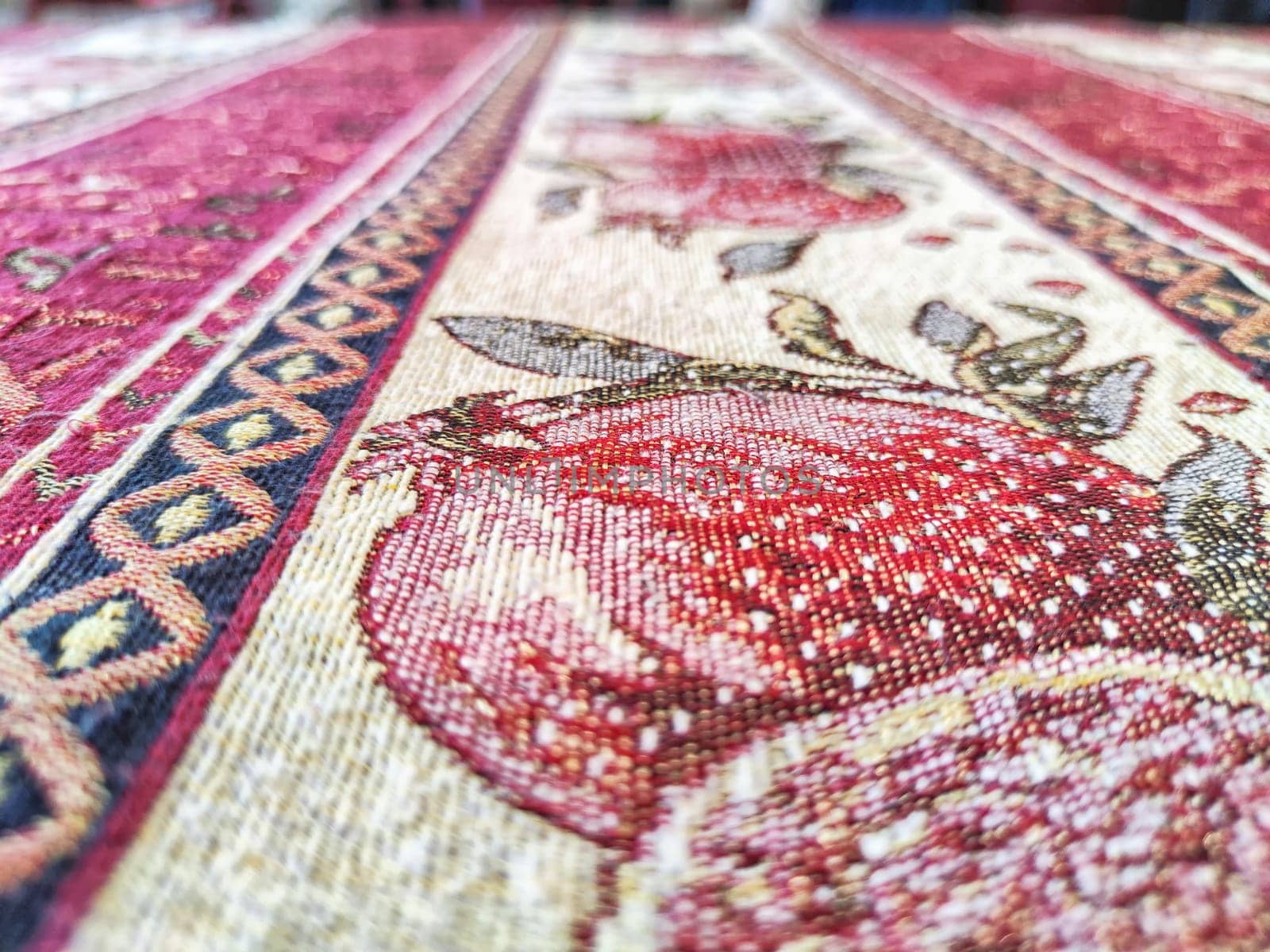 A tablecloth on the table or a carpet on the floor. Background, texture. Detailed texture of a patterned fabric surface