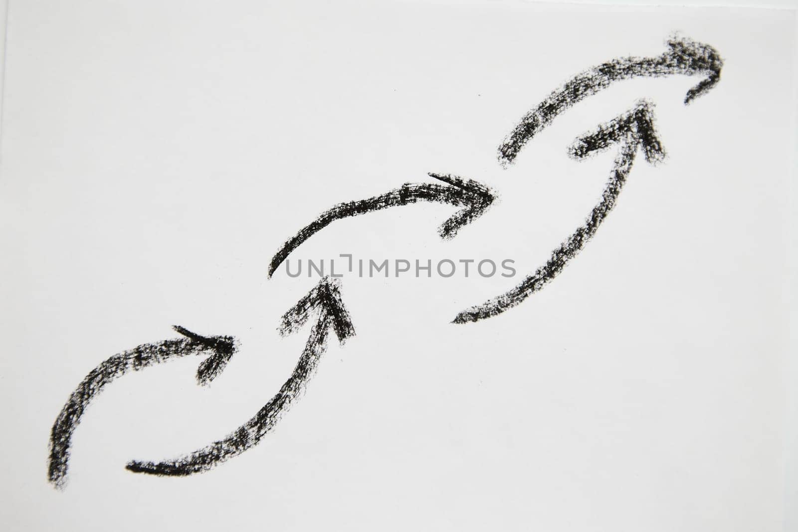 Many graceful smooth Hand drawn black chalk arrows like a chain. Concept of business, choosing direction, moving forward. Abstract sign, background, texture. Blurred