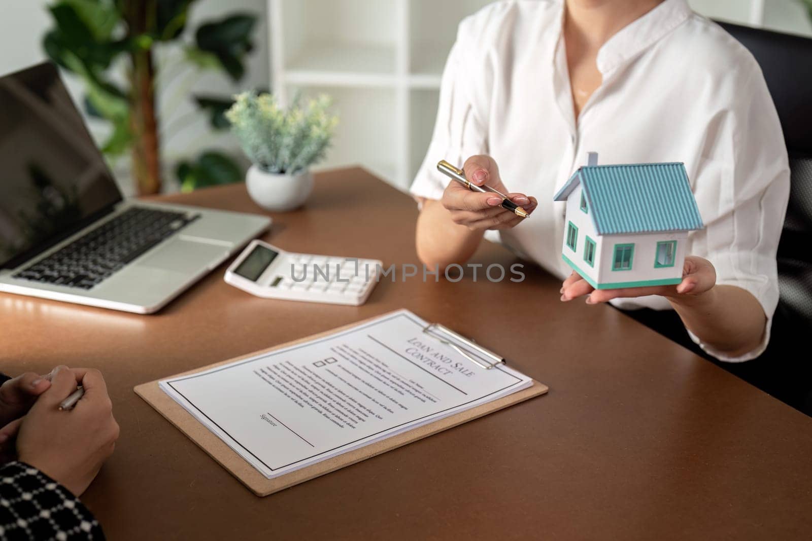 Real estate agent talking about the terms of the home purchase agreement and the customer to signing the documents to make the contract legally, Home sale and home insurance by nateemee