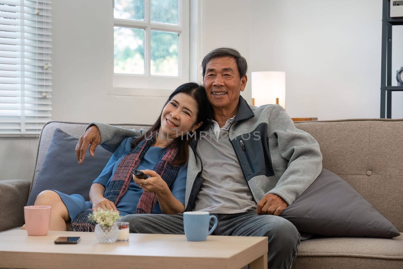 Relaxed elderly couple enjoying weekend together at home. senior retirement concept by itchaznong