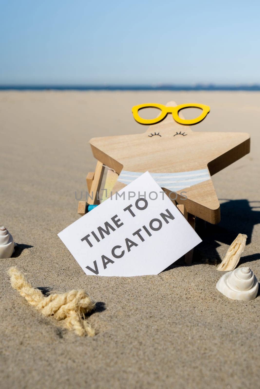 TIME TO VACATION text on paper greeting card on background of beach chair lounge starfish summer vacation decor. Sandy beach sun. Holiday concept postcard. Travel Business concept