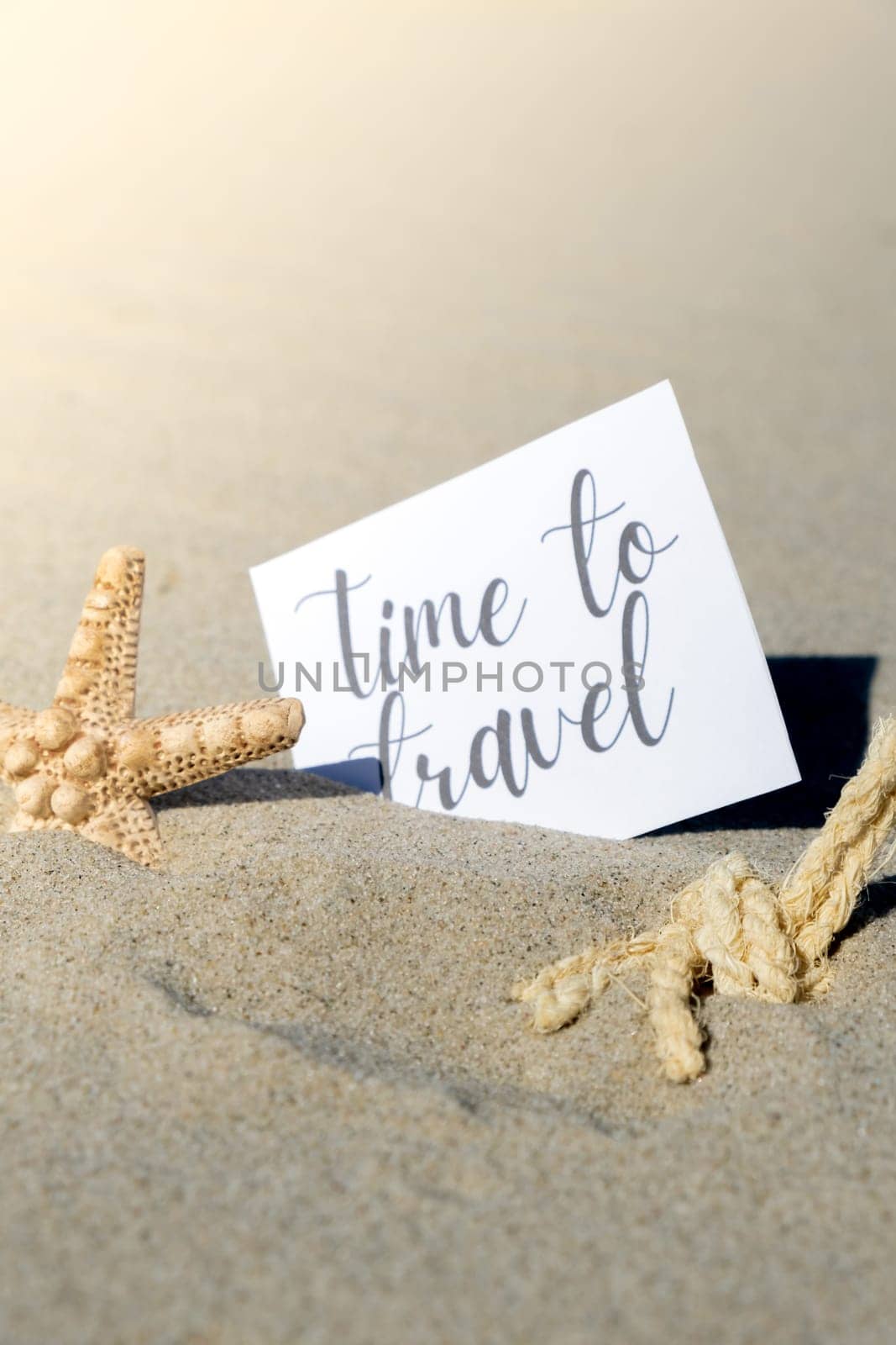 TIME TO TRAVEL text on paper greeting card on background of starfish seashell summer vacation decor. Sandy beach sun coast. Holiday concept postcard. Getting away Travel Business concept