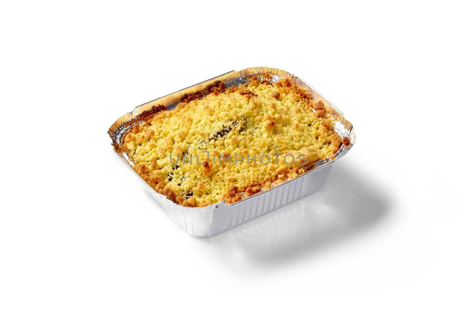 Delicious berry crumble pie with golden topping, baked to perfection and presented in disposable foil baking tray on white background