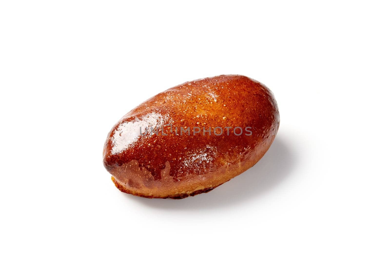 Golden-brown yeast leavened boat-shaped bun with glistening glaze and filling, isolated on white background. Popular comfort food in Eastern Europe