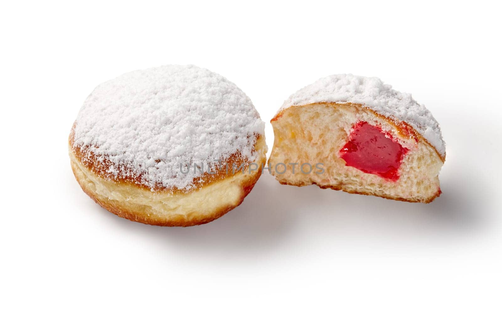 Tempting fluffy freshly baked doughnuts with aromatic strawberry filling, topped with powdered sugar, isolated on white background. Traditional sweets