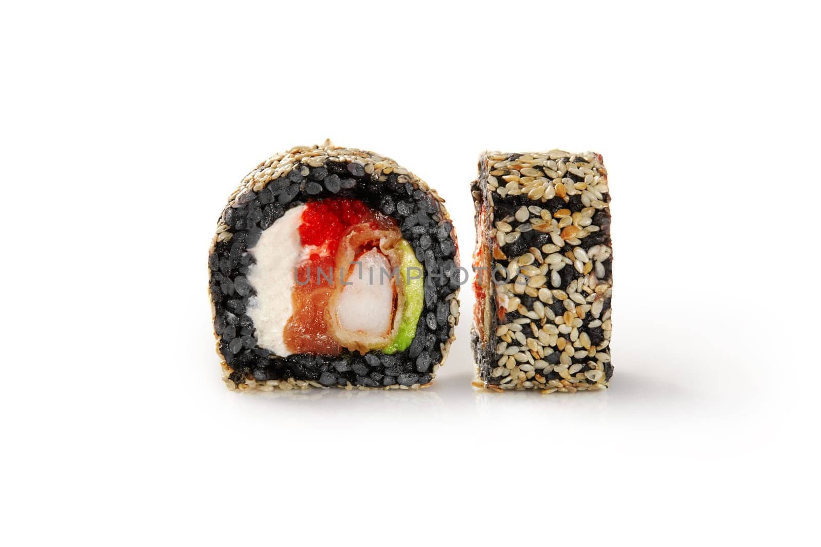 Close-up of appetizing black rice sushi roll filled with shrimp tempura, salmon, cream cheese, avocado, and fish roe generously sprinkled with sesame seeds, isolated on white background