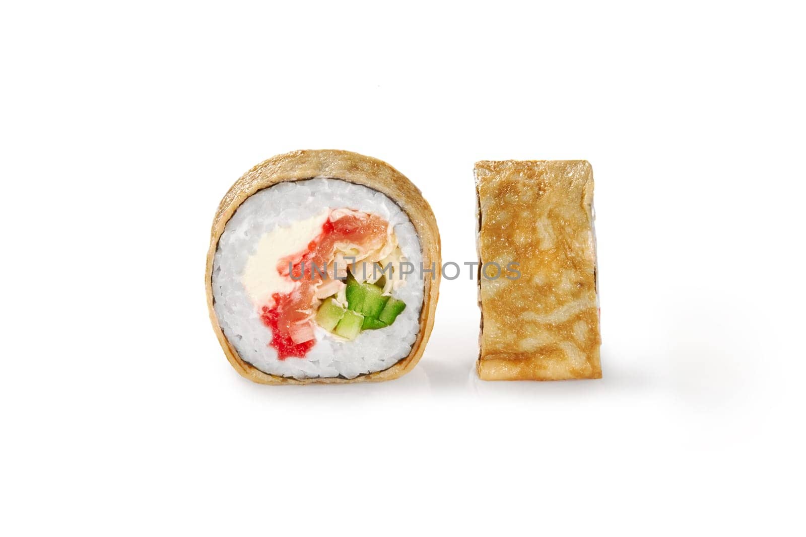 Delicious crepe sushi roll filled with salmon, tobiko roe, fresh cucumber and napa cabbage, closeup view isolated on white background