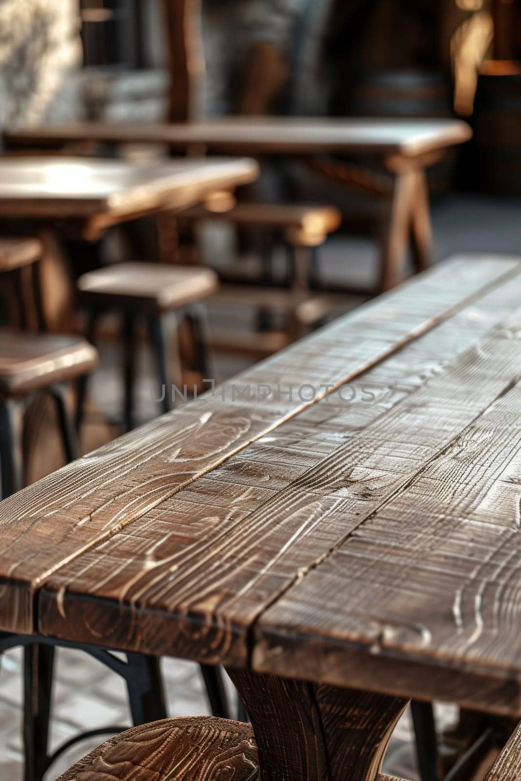 Warm sunlight bathes a rustic wooden table, highlighting the textured grain and natural imperfections. The table stands in a cozy cafe setting, inviting casual conversations and peaceful moments