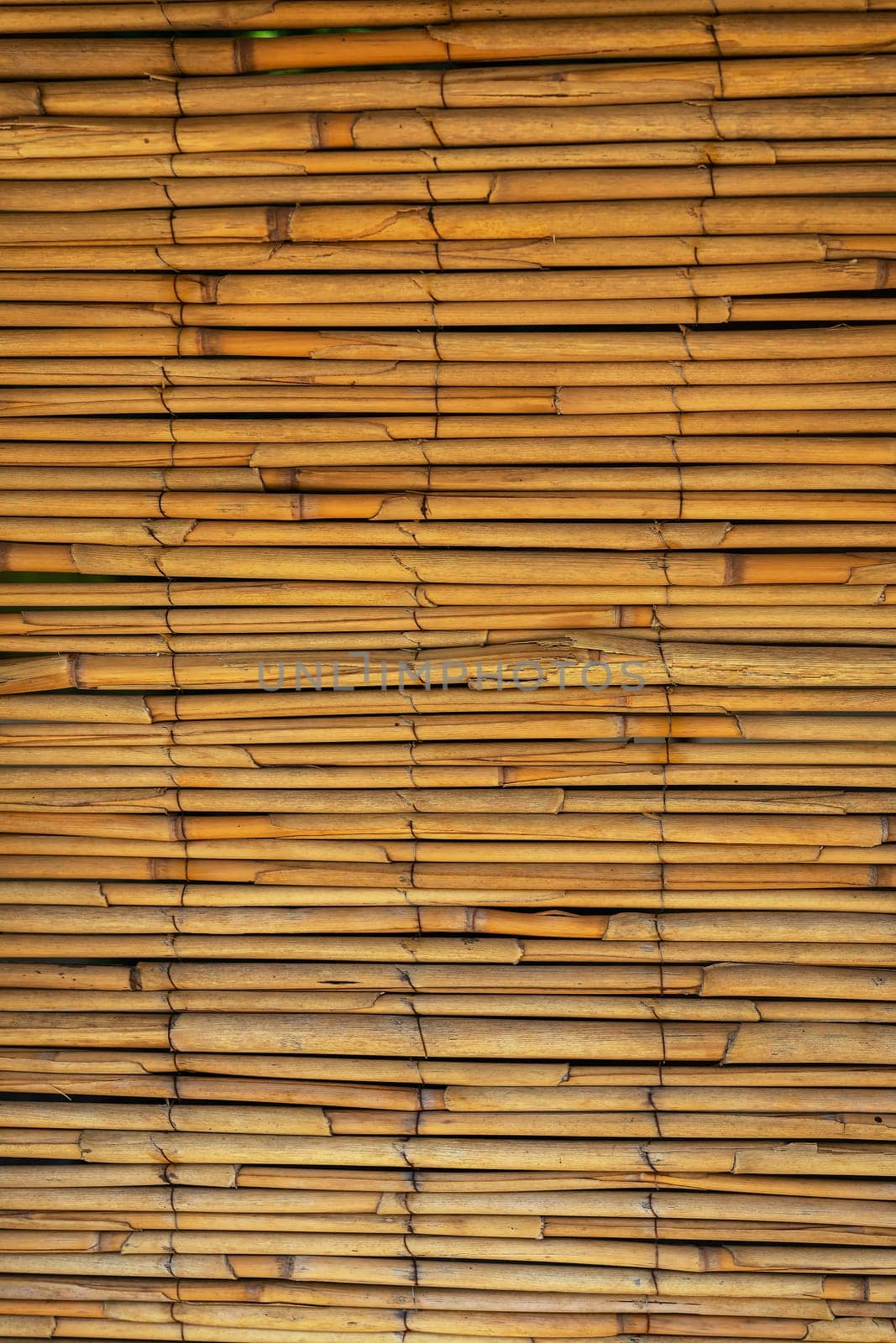 Close-up of a stacked bamboo mat, highlighting natural patterns and warm tones