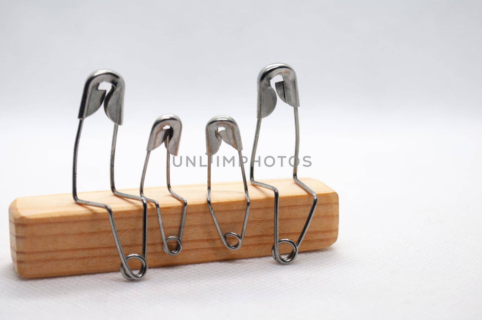 Safety pin represent family talking and sitting on wooden block with customizable space for text.