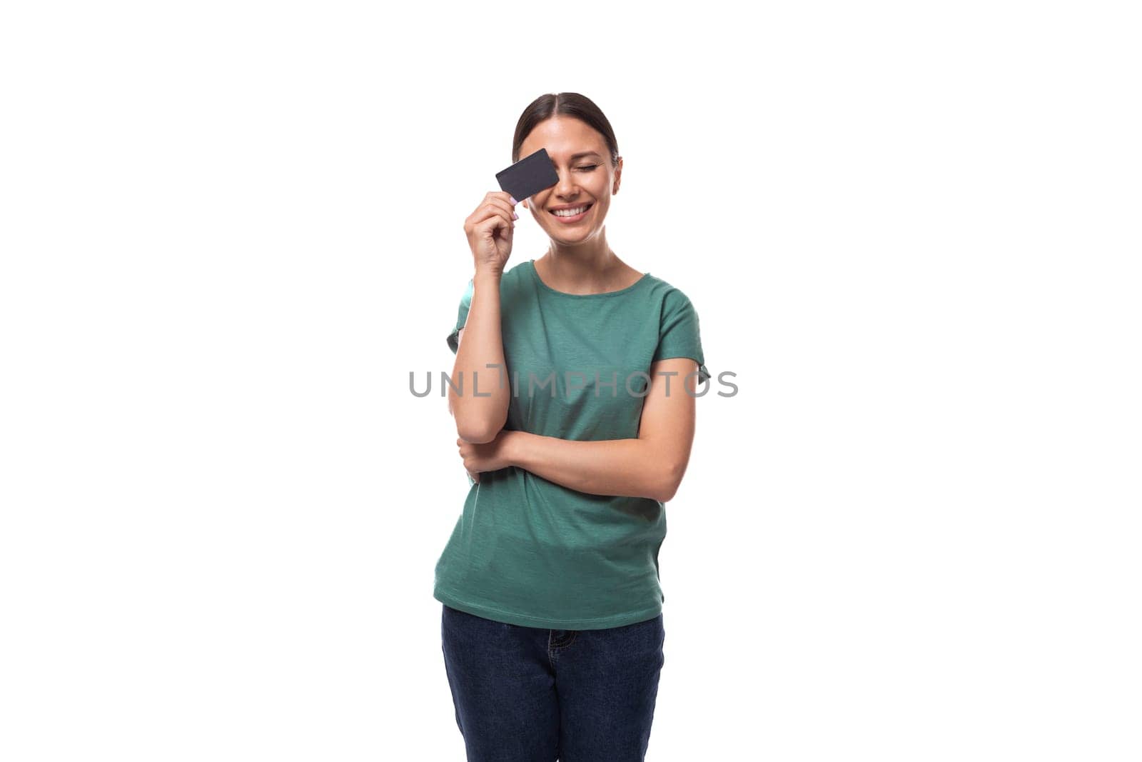 young black-haired woman dressed in a basic t-shirt holding a credit card by TRMK