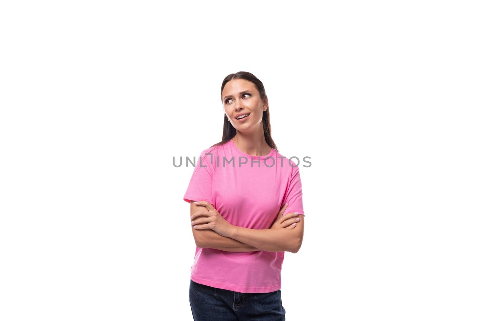 young slim caucasian brunette woman in a pink t-shirt on a white background with copy space by TRMK