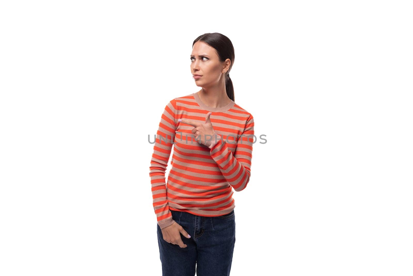 young adult woman dressed in an orange striped jacket looks away with surprise by TRMK