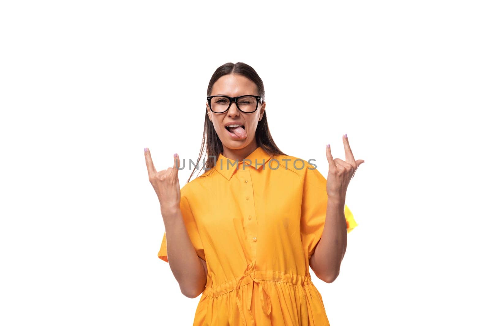 european young brunette lady dressed in orange summer dress shows cool gesture by TRMK