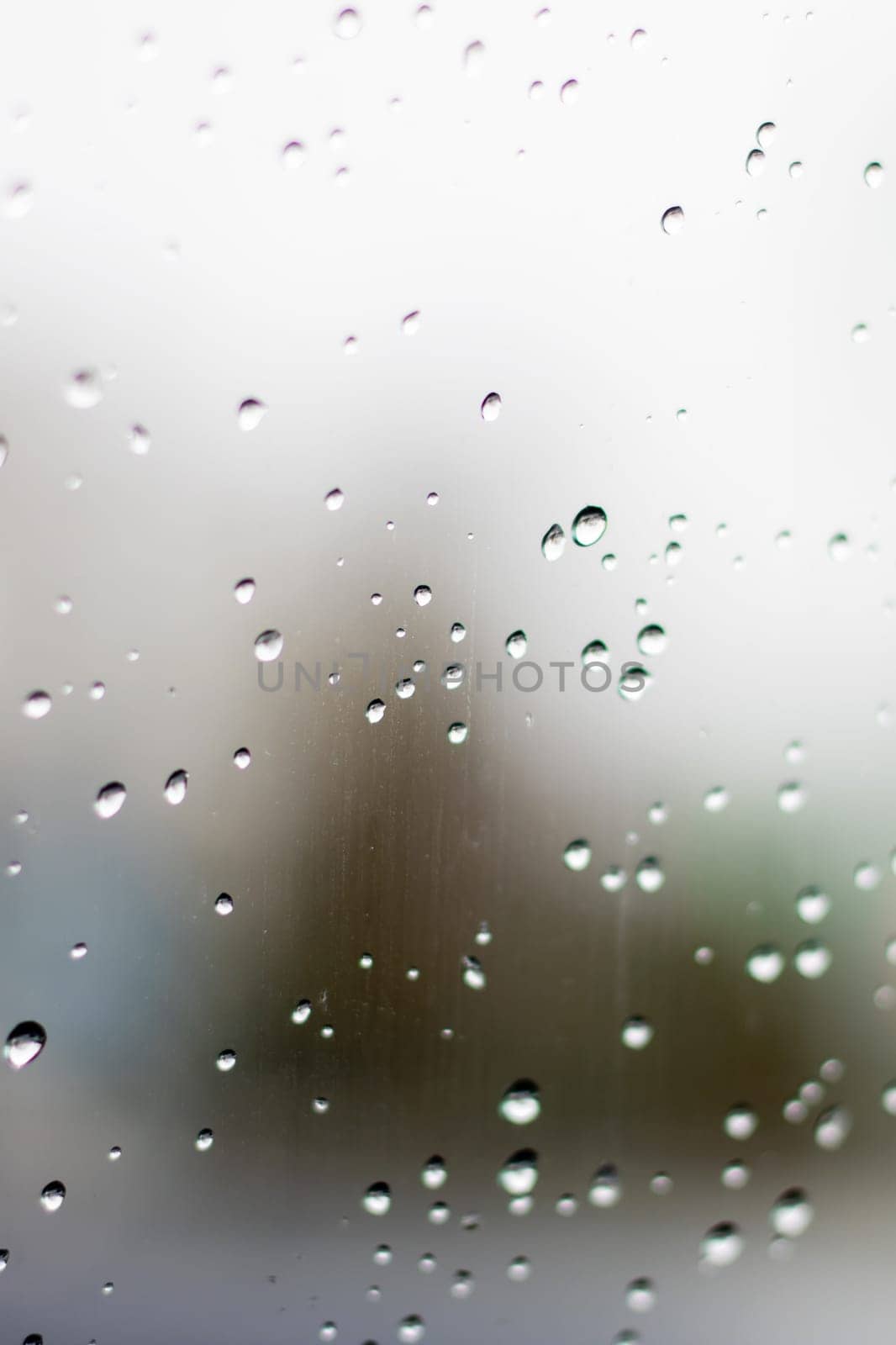 Electric blue rain drops on glass with blurry sky background by Vera1703