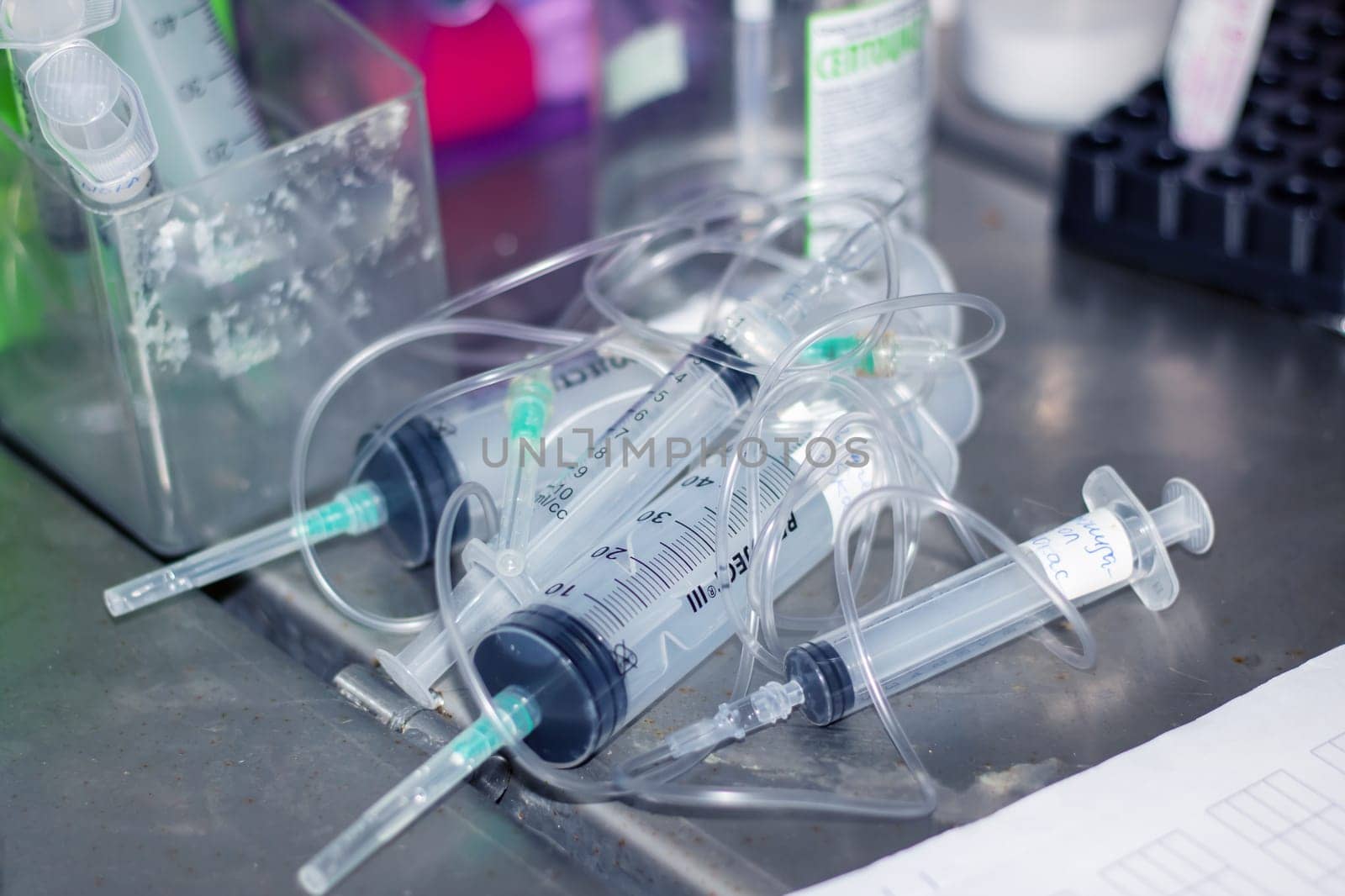 Liquidfilled syringes resting on table, ready for use by Vera1703