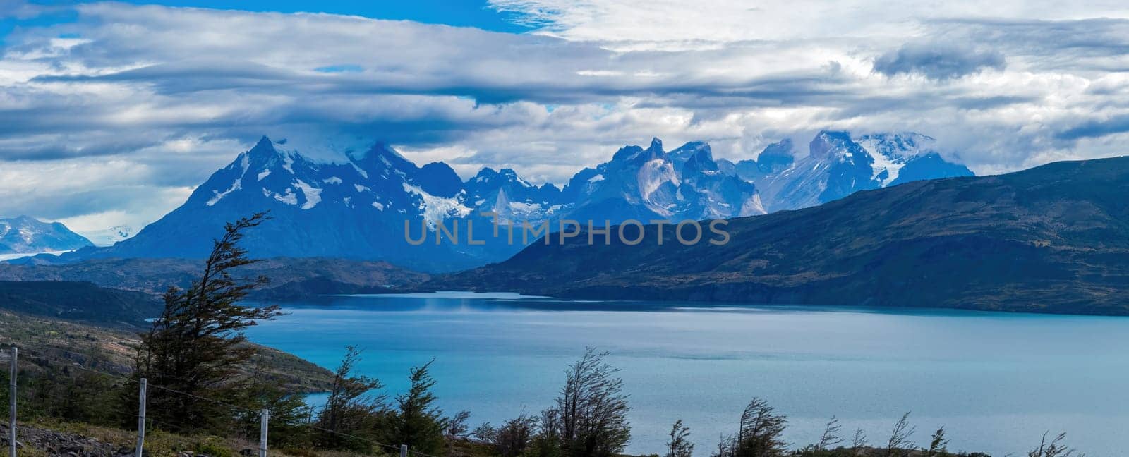 Majestic Mountain Range Overlooking a Serene Blue Lake by FerradalFCG