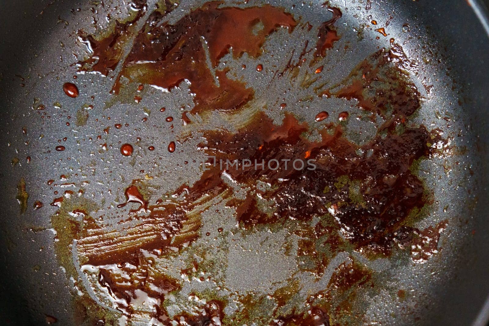 Detailed view of a frying pan filled with sizzling food being cooked