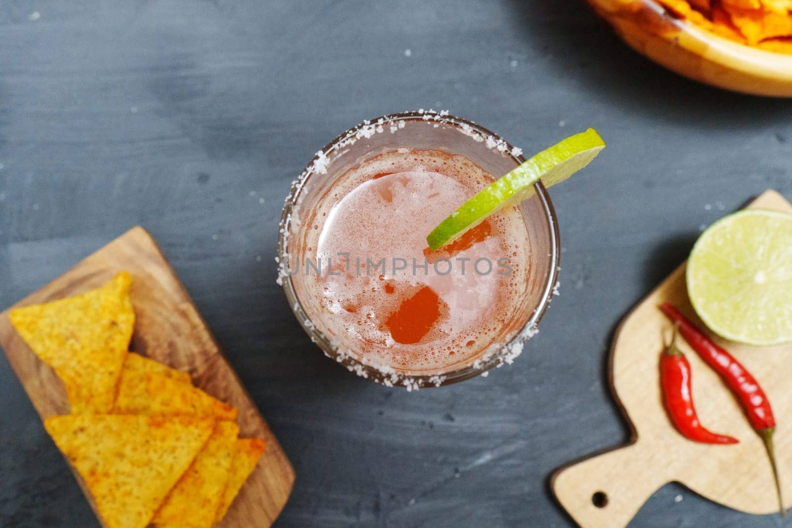Mexican cocktail, michelada, made with beer and tomato juice. Selective focus by darksoul72