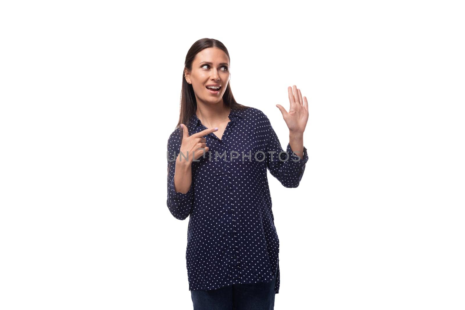 young european slim brunette woman in blue clothes looks confident on a white background.
