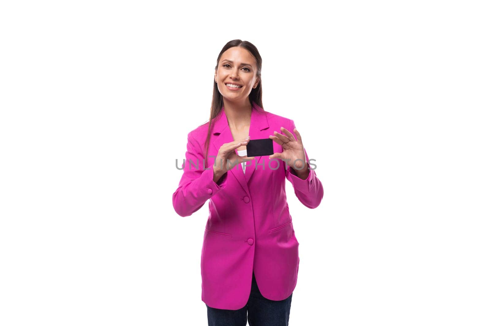 a young slender well-groomed brunette business woman dressed in a crimson chic suit uses a credit card and online payments.