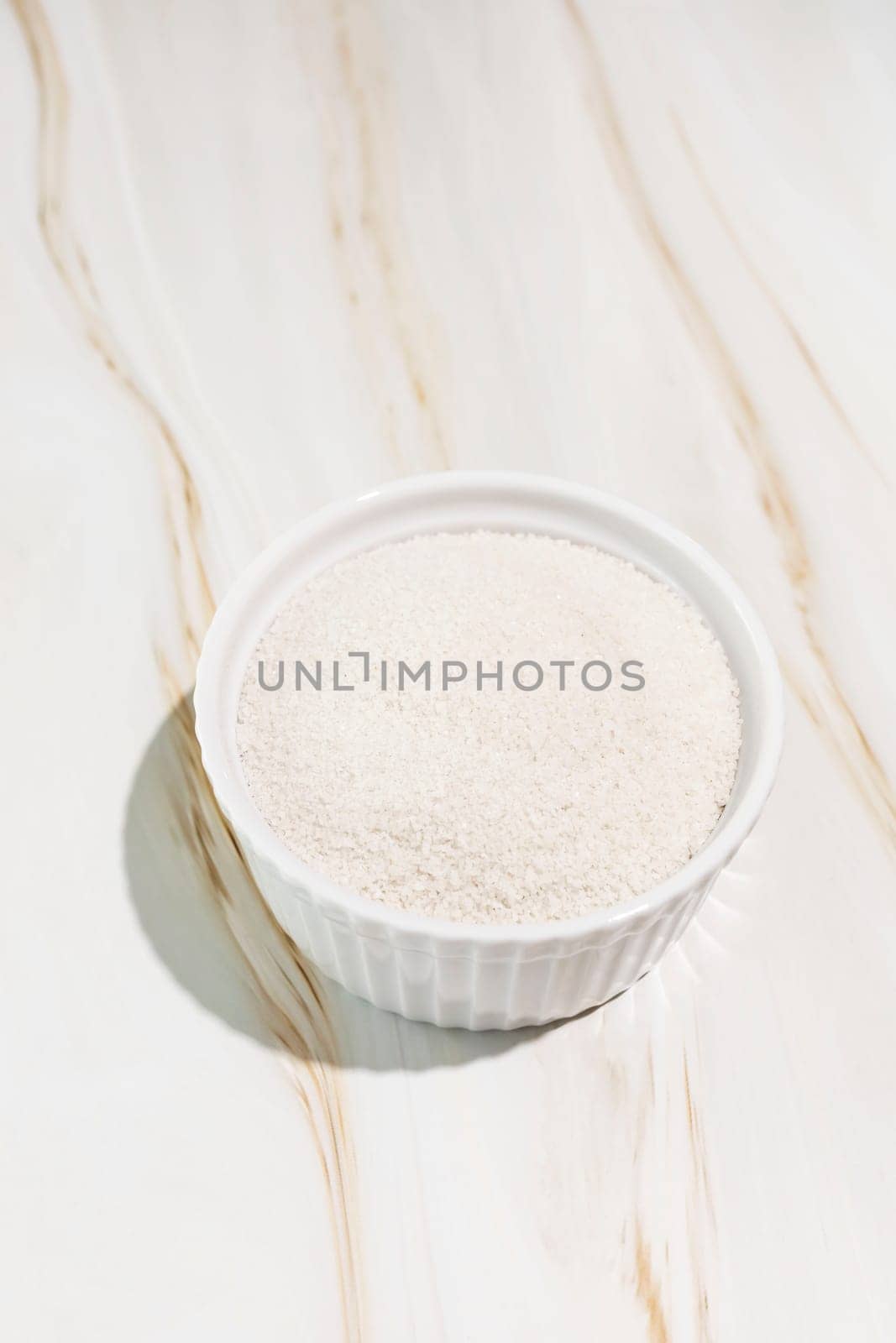 Celtic Gray Sea Salt In A White Ceramic Bowl On Granite Table, Copy Space. Vertical Plane. Natural And Unrefined Salt Harvested From Brittany, France. Natural Minerals And Trace Elements, Superfood by netatsi
