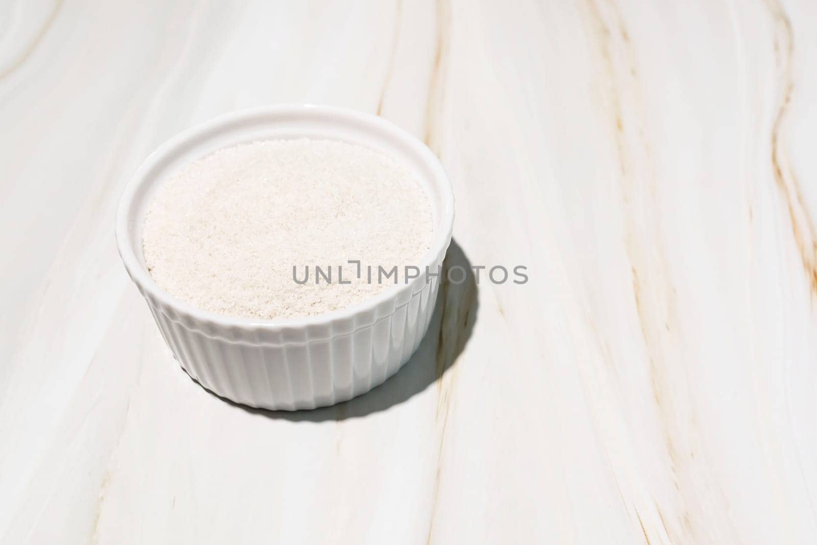 Celtic Gray Sea Salt In A White Ceramic Bowl On Granite Table, Copy Space. Horizontal Plane. Natural, Unrefined Salt Harvested From Brittany, France. Natural Minerals And Trace Elements, Superfood by netatsi