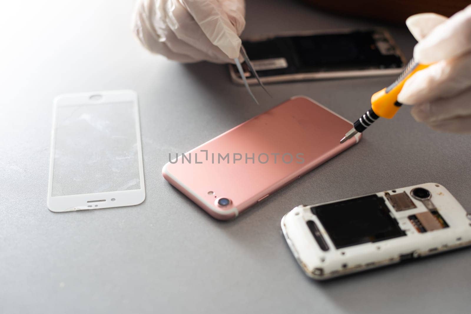 Close-up photos showing process of mobile phone repair by Andelov13