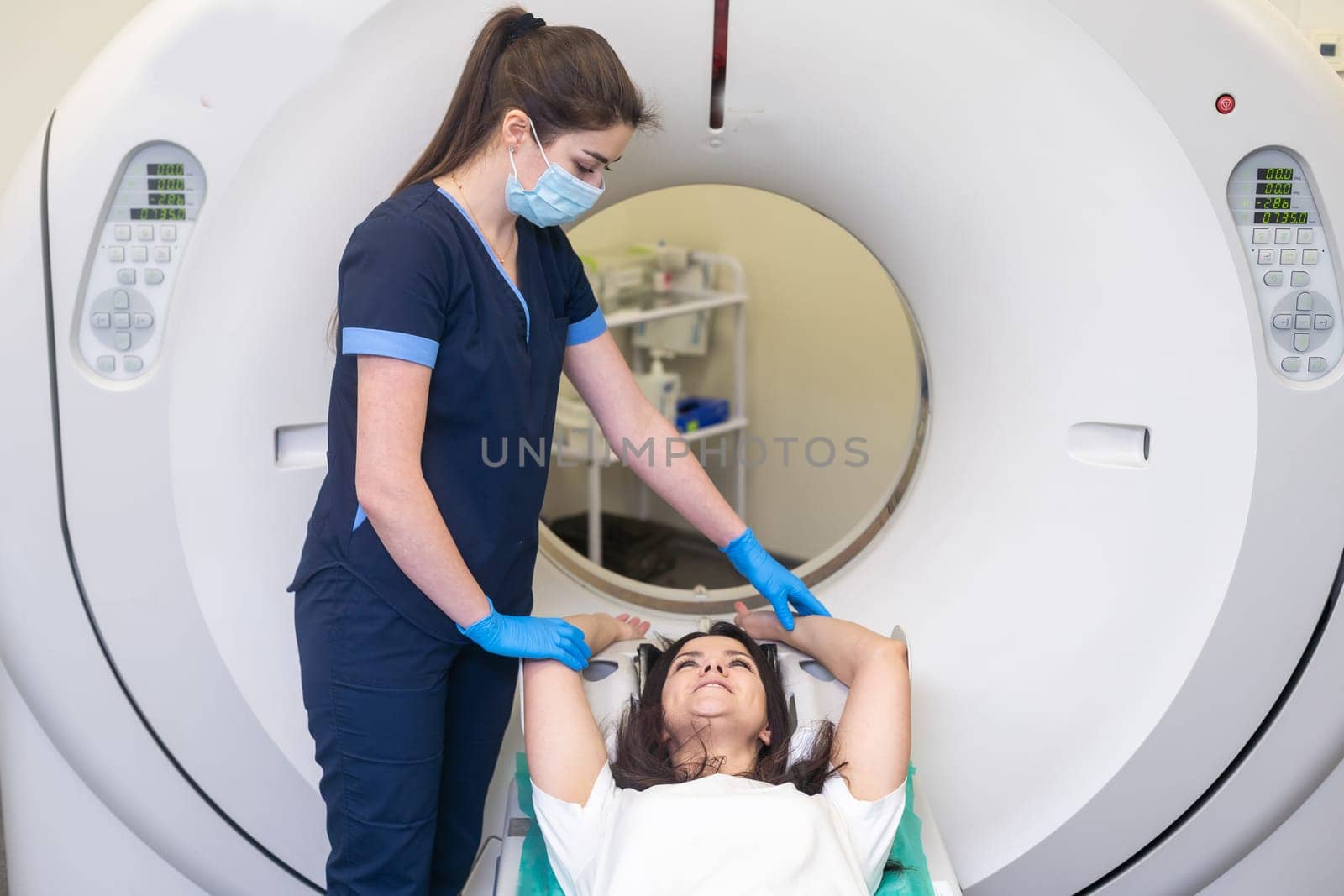 Doctor doing computed tomography for female patient stock photo. Medicine diagnostic concept.