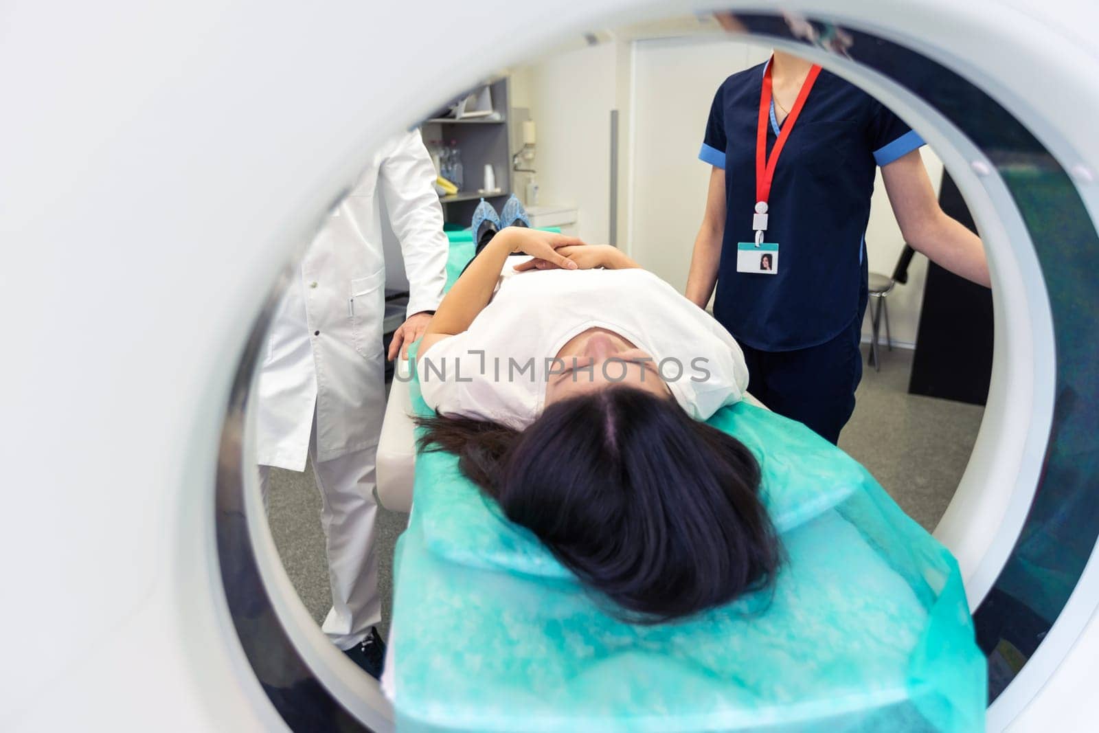 Radiologist with a female patient in the room of computed tomography. by Andelov13