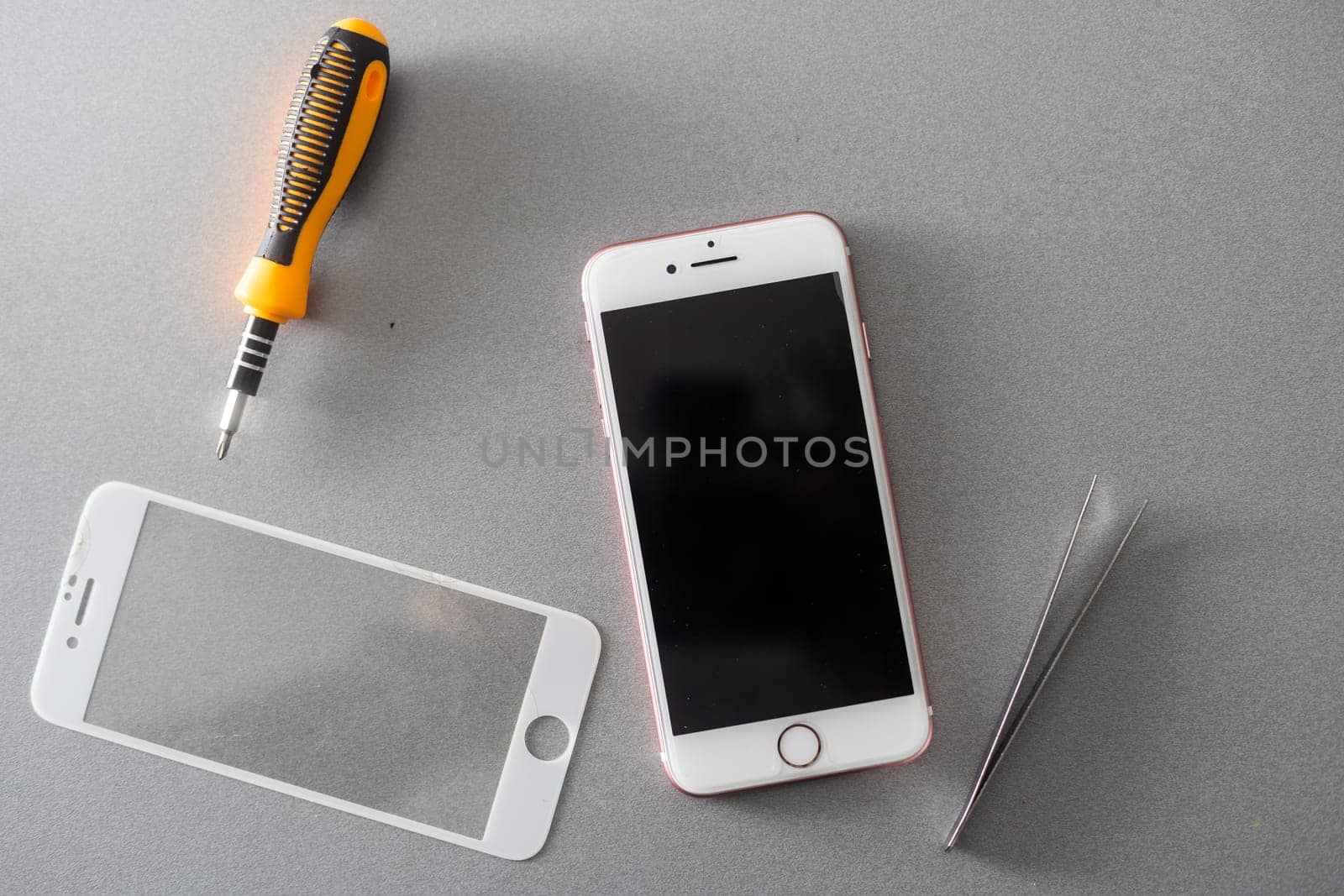Smart solution technology concept. cropped photo replacement of protective film with a new one. Man carefully removes old protective glass from the smartphone screen