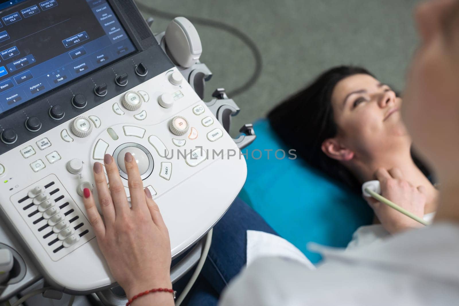 Woman endocrinologist making ultrasonography to a female patient in an ultrasound office. Ultrasound diagnostics.